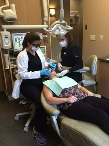 Dr. Reynolds, along with the assistance of Kim, examines a patient.