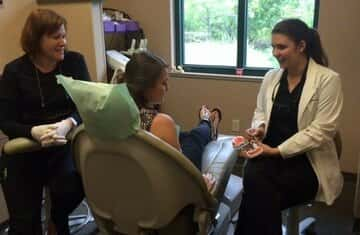 Dr. Reynolds educating her patient regarding their dental health.